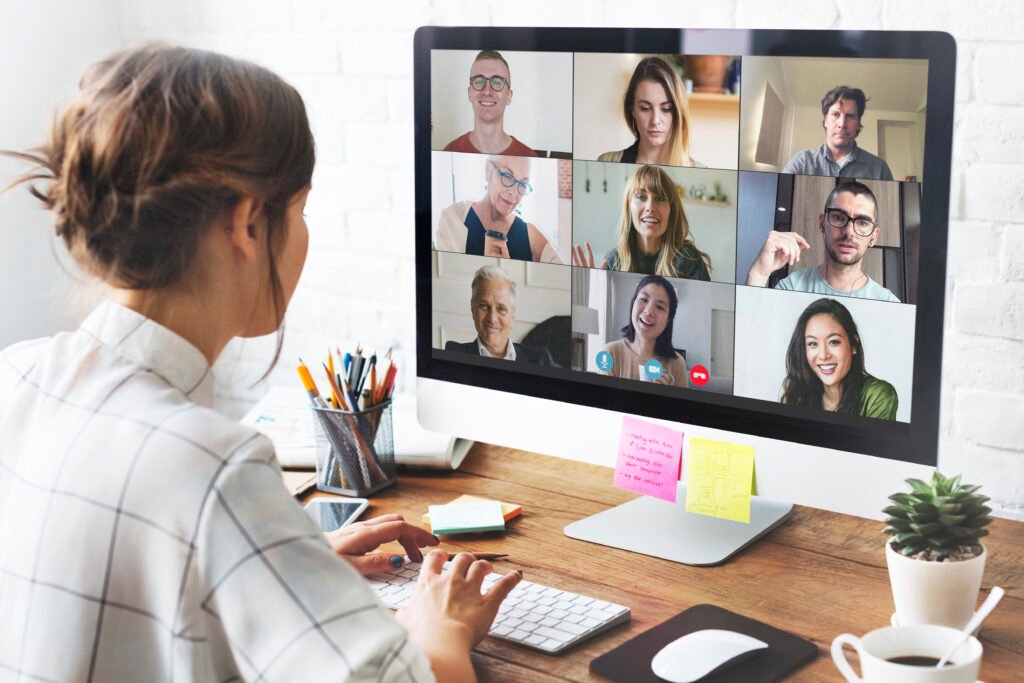 People in a virtual meeting using Zoho Meeting on laptop